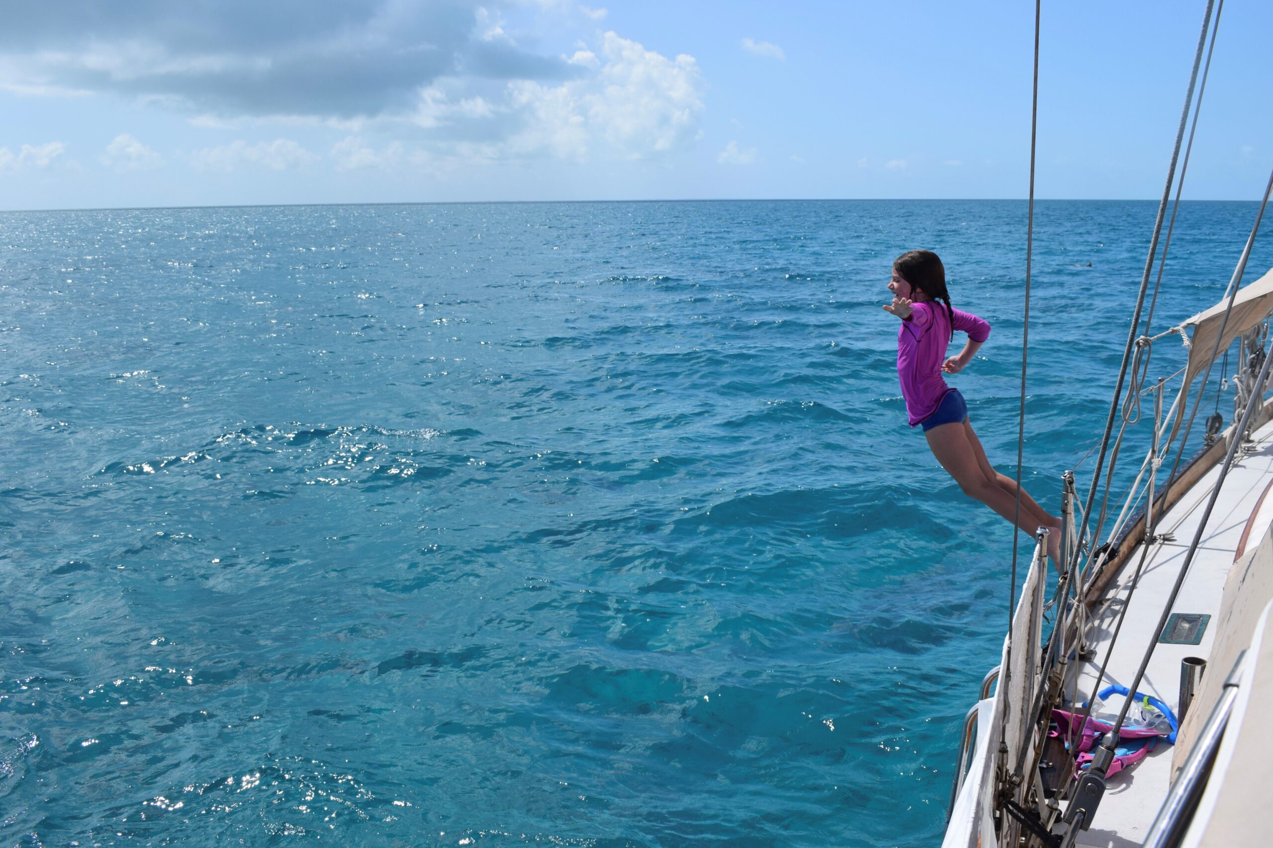 girl jumping off sailboat