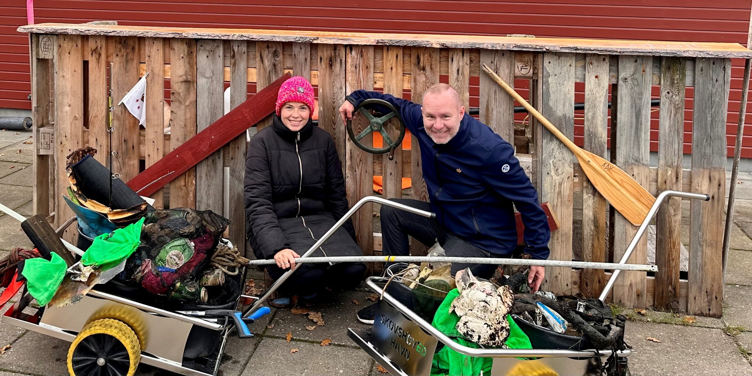 Sailors for the Sea Skipper Bjarne Nielsen (right) and a volunteer show off what they collected during a harbor cleanup. 
